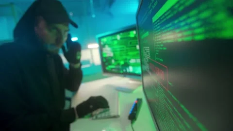 Hacker is typing on a computer keyboard and cracking a password. A man in a Stock Footage 233596019