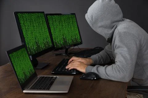Hacker Typing On Computers With Binary Code At Desk 库存照片