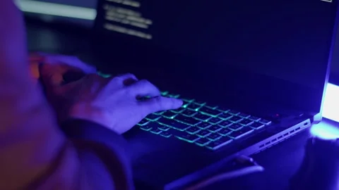 The hacker is typing fast on the keyboard due to the approach of the police Stock Footage 194789745