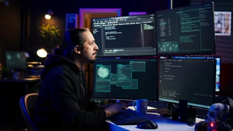 Hacker typing fast on keyboard, rushing to finish developing spyware software Stock Footage 275754982