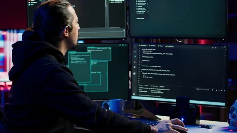 Hacker typing fast on keyboard, rushing to finish developing spyware software Stock Footage 275762483