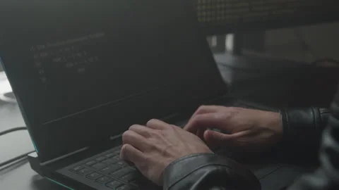 Hacker Typing on His Laptop Keyboard in His Basement Stockbeeldmateriaal 208727247