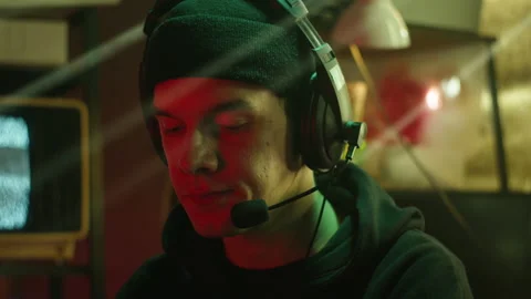 Hacker typing on keyboard at night, breaking password, wearing headphones with Stock Footage 158926740