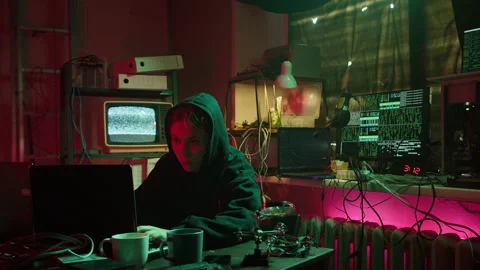 Hacker typing on keyboard at night, breaking password, wearing black hoodie 動画素材 160493630