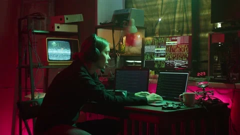 Hacker typing on keyboard at night, breaking password, using laptop and wearing Stock Footage 160941414
