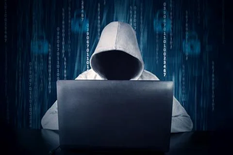 Hacker typing on a laptop with binary code in background 库存照片