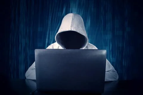 Hacker typing on a laptop with binary code in background 库存照片