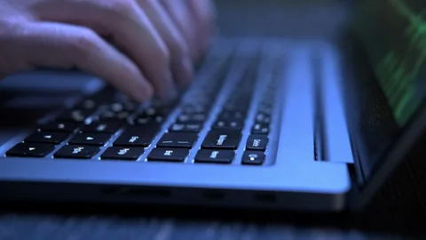Hacker typing on laptop keyboard. Close-up of hands stroking keys Video stock 129620966