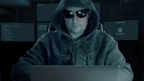 Hacker typing at laptop. Man coding on computer dark night. Man in dark glasses Stock Footage 82819515