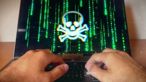 Hacker typing as malware warning symbol displays on screen Stock Footage 286088747