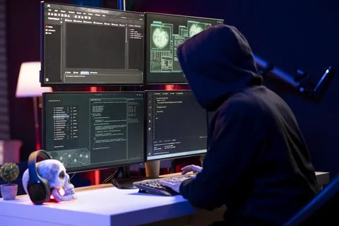 Hacker typing on PC keyboard, using malicious spyware program Fotos de archivo