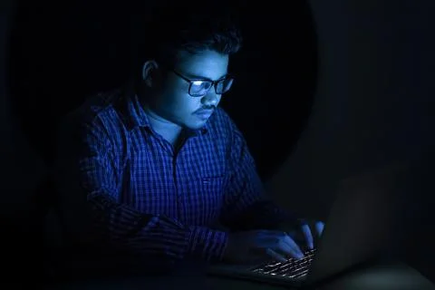 Hacker typing programming code at mid night Foto stock