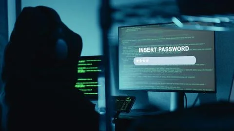 Hacker typing security password for login breaks in company data servers. Hacker Stock Photos