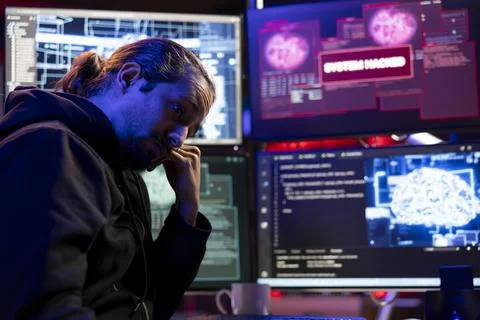 Hacker in underground lair using AI on on computer to break into systems 스톡 사진
