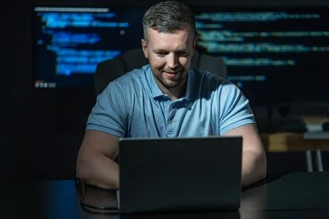 Hacker uses computer for cyber attack. Hacker writes malicious code on screen Stock Photos