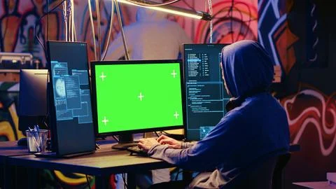 Hacker uses green screen PC to code Foto stock
