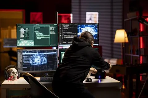Hacker using AI deep learning to code malware designed to exploit backdoors Stock Photos