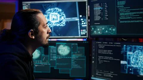 Hacker using AI machine learning on computer to produce malware corrupting data Stock Photos