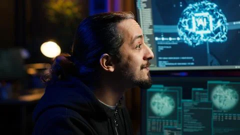 Hacker using AI machine learning on computer to produce malware corrupting data Stock Photos