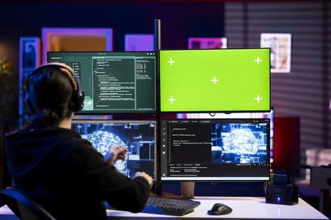 Hacker using artificial intelligence on green screen PC to steal credit cards Stock Photos