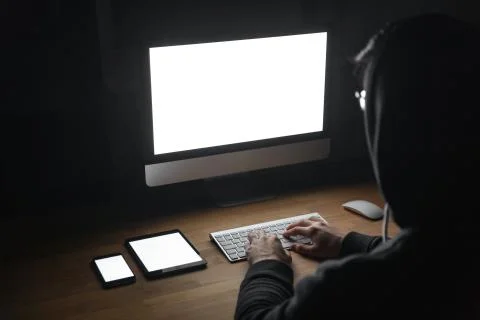 Hacker using blank screen computer, tablet and cell phone Stock Photos
