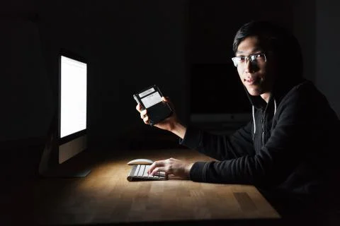 Hacker using computer and stealing information from hard disk Stock Photos