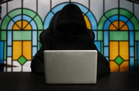 Hacker using computer with digital interface while sitting at desk of blurr.. Fotos Stock