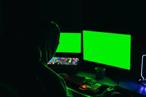Hacker using computer to organise massive data breach attacks on public servers Stock Photos