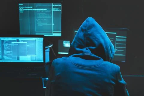 Hacker using computer for organizing massive data breach attack on goverment 스톡 사진