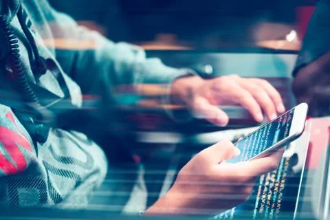 Hacker using computer, smartphone and coding to steal password and private da 写真素材