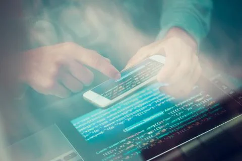 Hacker using computer, smartphone and coding to steal password and private da Stock Photos