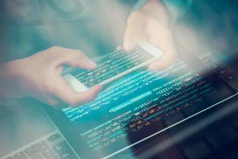 Hacker using computer, smartphone and coding to steal password and private da Foto stock