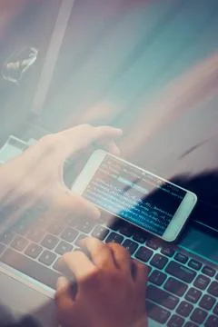 Hacker using computer, smartphone and coding to steal password and private... Foto stock