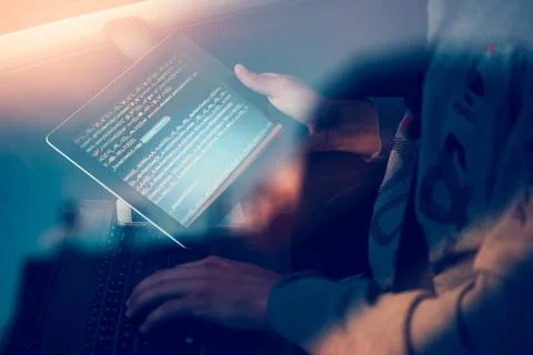 Hacker using computer, smartphone and coding to steal password and private... Foto stock