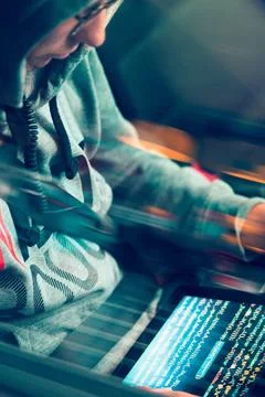 Hacker using computer, smartphone and coding to steal password and private... Foto stock