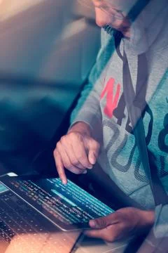 Hacker using computer, smartphone and coding to steal password and private... Stock Photos