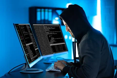 Hacker Using Computer To Write Exploit Stock Photos