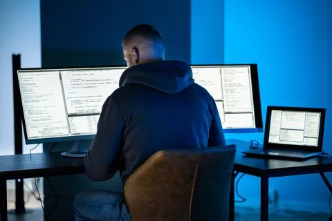 Hacker Using Computer To Write Exploit Stock Photos