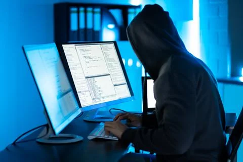 Hacker Using Computer To Write Exploit Stock Photos