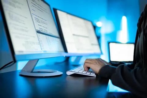 Hacker Using Computer To Write Exploit Stock Photos