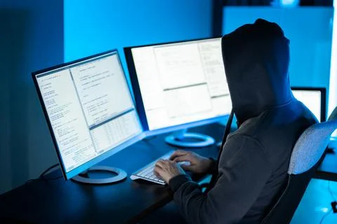 Hacker Using Computer To Write Exploit Stock Photos