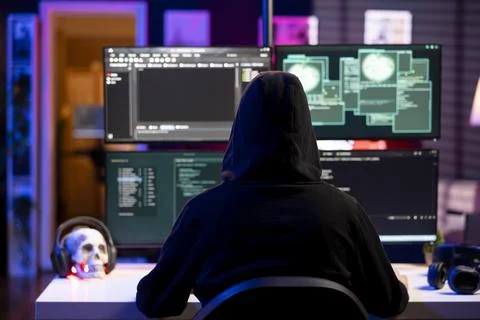 Hacker using exploits on computer to break into systems Stock Photos