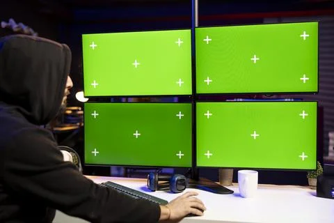 Hacker using green screen computer displays to extract military secrets data 写真素材