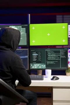 Hacker using green screen PC to gain unauthorized network access Stock Photos