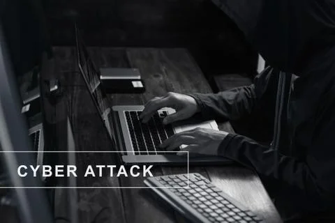 Hacker using laptop and hack password code in dark room. Stock Photos