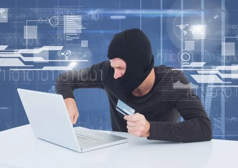 Hacker using a laptop and holding a credit card in front of 3D digital 写真素材