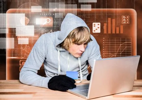 Hacker using a laptop and holding a credit card in front of 3d digital orange Foto stock