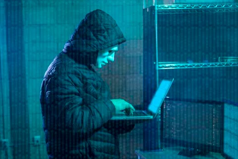 Hacker using laptop with binary code Foto stock