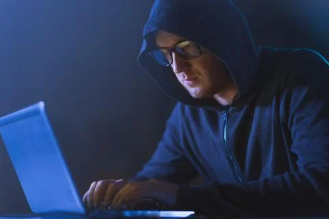 Hacker using laptop computer for cyber attack Stock Photos