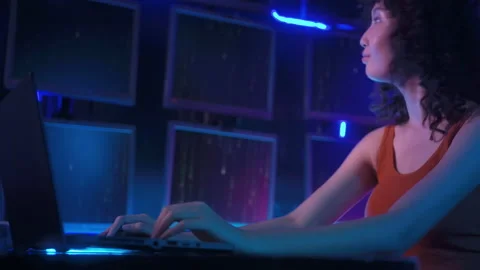 A Hacker is using laptop computer to steal data in the night Stock Footage 232945393